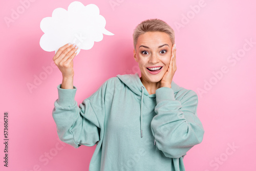 Photo portrait of pretty young girl hold paper cloud excited palm touch cheek wear trendy khaki outfit isolated on pink color background
