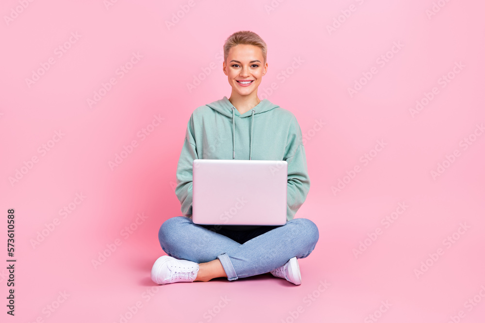 Full length photo of adorable pretty lady wear stylish clothes use modern netbook device isolated on pink color background Full length photo of adorable pretty lady wear stylish clothes use modern netbook device isolated on pink color background
