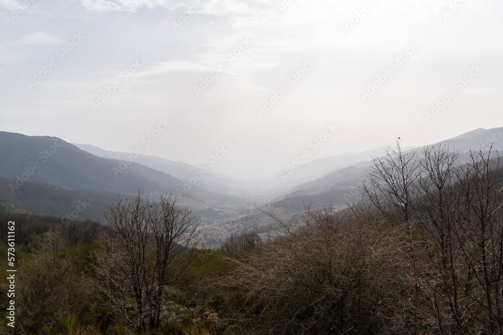 Panoramic view of Tornavacas in the Jerte Valley with a little fog, in the north of Cáceres, Extremadura, Spain Panoramic view of Tornavacas in the Jerte Valley with a little fog, in the north of Cáceres, Extremadura, Spain