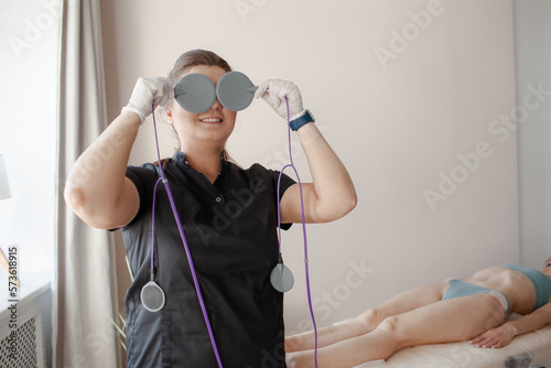  hardware cismetology specialist does a procedure to improve the wuality of the girl's skin photo