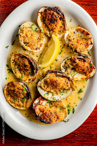 Little Neck Clams. Fresh clams served with garlic, shallots, cocktail sauce, mignonette sauce and fresh lemons and limes. Classic American steakhouse or French bistro appetizer.