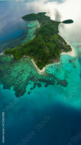 aerial drone view of a tropical island with some tourist villages and fishing villages, Darocotan island in philippines. travel concept