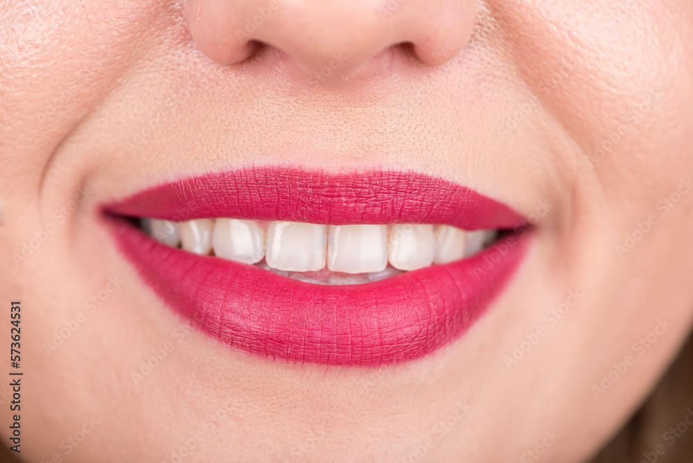 Fototapeta premium Woman Face With Pretty Smile and White Teeth. Studio Photo Shoot. Use Bright Red Lipstick.