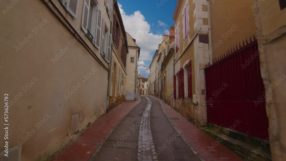 Video captures the view of a stunning street located in the center of Auxerre, showcasing the city's rich history and French legacy. Street with old traditional French houses Video captures the view of a stunning street located in the center of Auxerre, showcasing the city's rich history and French legacy. Street with old traditional French houses