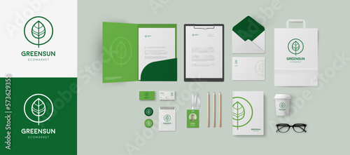 Corporate identity template in green colors with minimal style leaf logo for branding eco market, clinic, cosmetology salon or wellness company. Folder and business cards, bag and envelope mockup set
