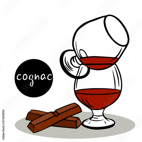 set of cognac composition. Two glasses of cognac stand on top of each other and two pieces of chocolate bars. brandy or cognac. two glass glasses with remnants of alcohol. for menu or poster.