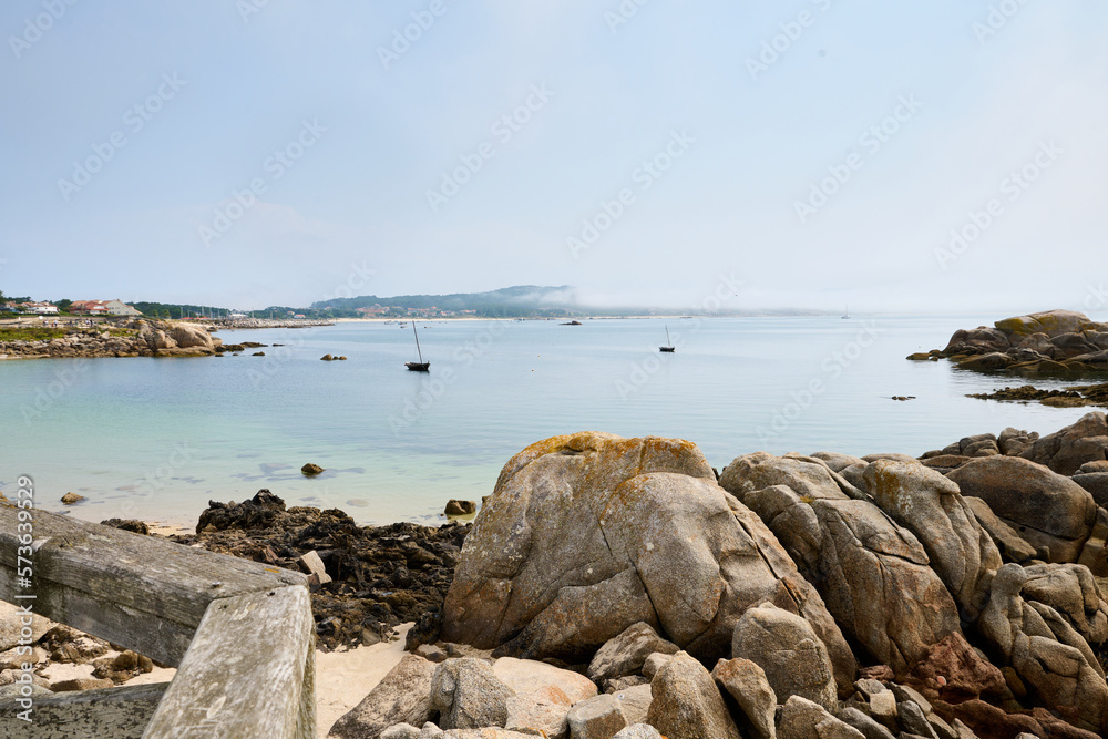 Galician beach with rocks and blue sky. Nature background. Galician beach with rocks and blue sky. Nature background.