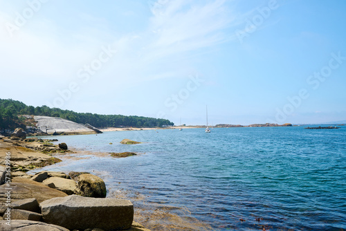 Galician beach with rocks and blue sky. Nature background. © Carlos