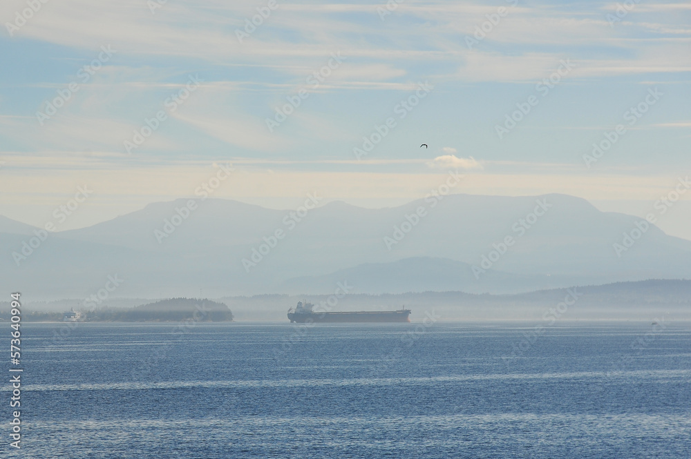 large ship in the ocean on a foggy cloudy morning near Vancouver, British Columbia, Canada