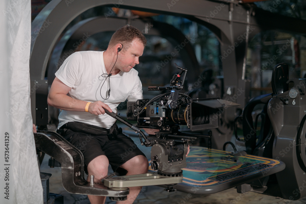 Director of photography with a camera in his hands on the set. Professional videographer at work on filming a movie