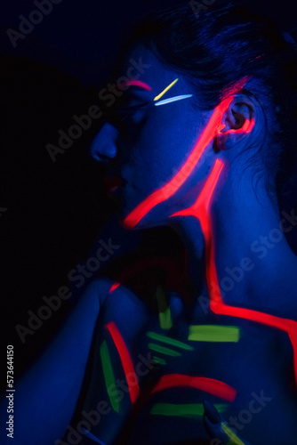 Model woman in neon light, beautiful model girl with fluorescent makeup, art design of disco dancer dancing in uv light, colorful makeup. Nightclub, Party. 4K video.
