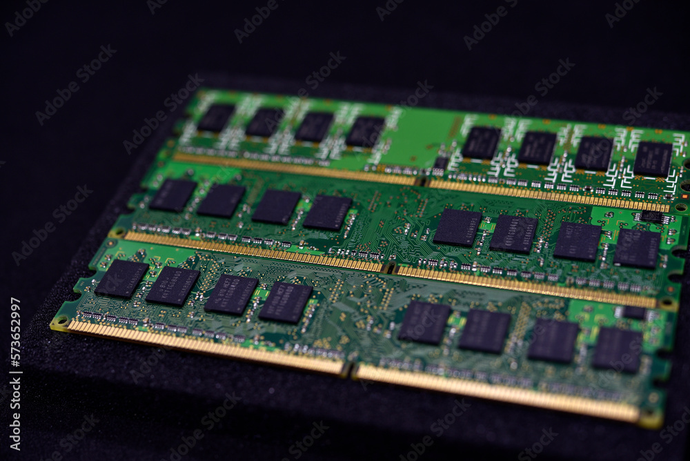 Green RAM strips on black foam. Computer chips close-up. Microchips and memory chips. Green RAM strips on black foam. Computer chips close-up. Microchips and memory chips.