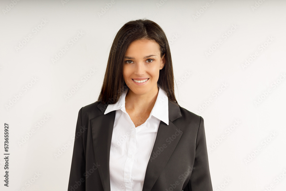 Portrait of happy smiling brunette businesswoman dressed in white shirt and black jacket. Beautiful model on isolated white background. Studio shot of young attractive woman in business suit. Portrait of happy smiling brunette businesswoman dressed in white shirt and black jacket. Beautiful model on isolated white background. Studio shot of young attractive woman in business suit.