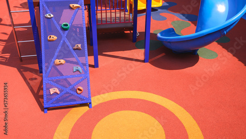 Konstfotografi Jungle gym and slider with playground equipments on colorful rubber floor in out