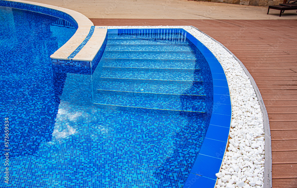 Elements of a swimming pool. Beautiful swimming pool with blue tiles closeup.