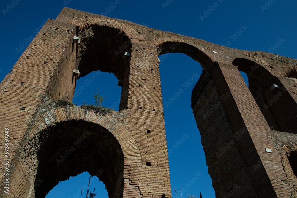 Torre del Fiscale park, shot from below of the Felice aqueduct, ancient walls, blue sky in the background.