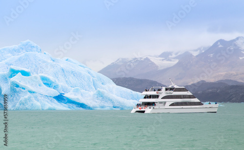 Boat passing iceberg in Patagonian waters