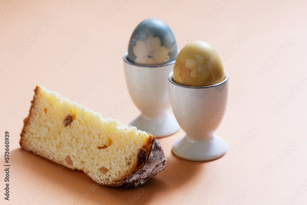 Easter still life, a slice of Easter cake and eggs dyed with natural dyes.