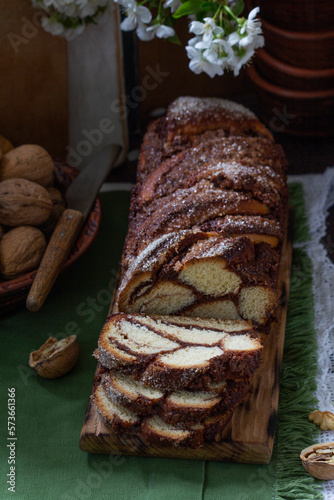 Obraz na płótnie Traditional Easter bread with chocolate and nut filling on a wooden background. w salonie