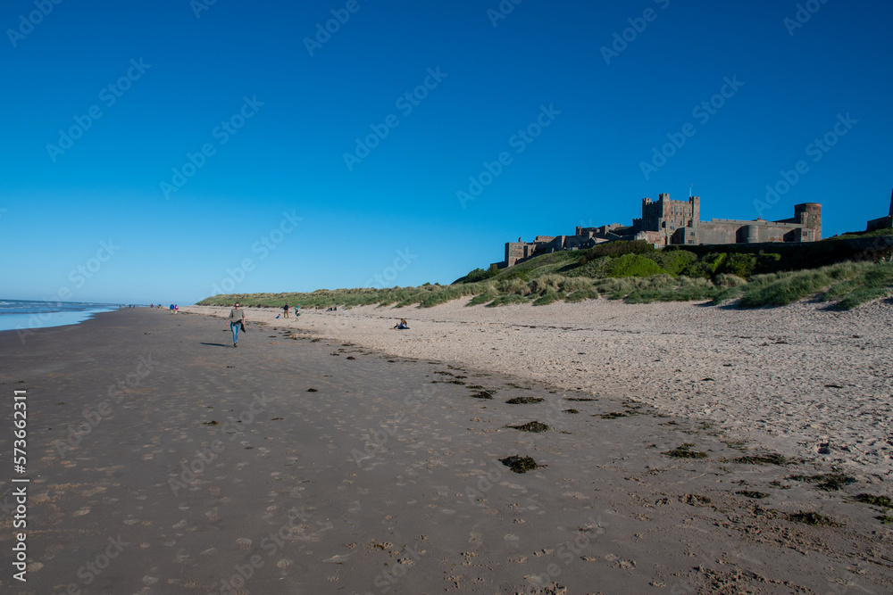 Bamburgh Castle views from the beach on a hot summer's day. Northumberland, UK
