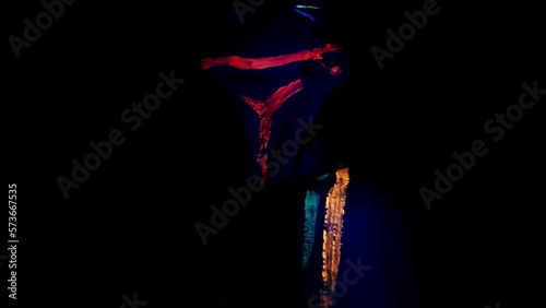 Portrait of a beautiful woman with blue sequins on her face. Girl with artistic make-up in Light color. Fashion model with colorful makeup.