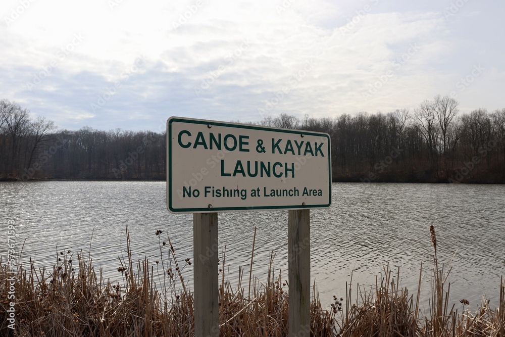 The green and white canoe kayak launch sign.