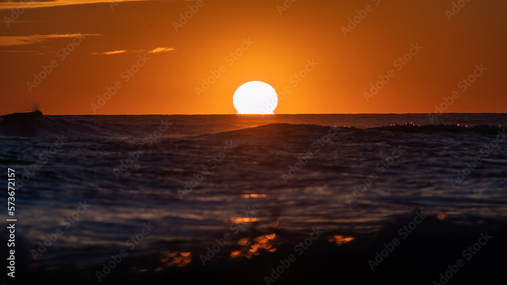 The sphere of the sun in a sunset in the sea
