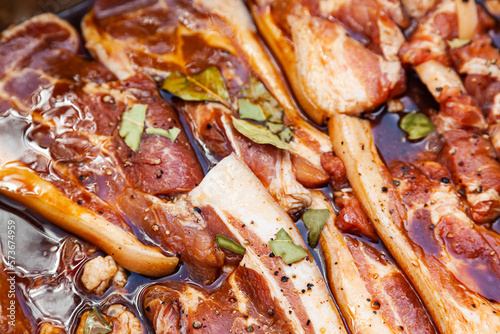 Bacon in brine with spices. Sliced pork soaked in brine with spices.