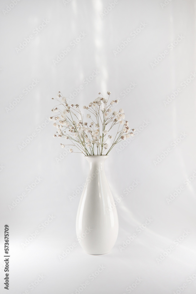 white vase with flower