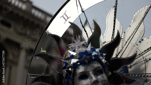 Venice - carnival masks are photographed with tourists in San Marco square