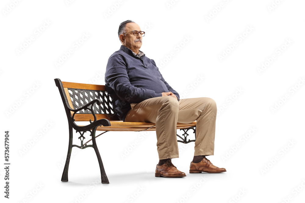 Serious mature man sitting on a bench and thinking