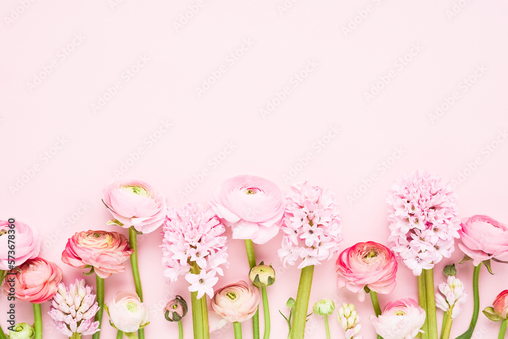 Pink ranunculus and hyacinths on a light pink background. Greeting card