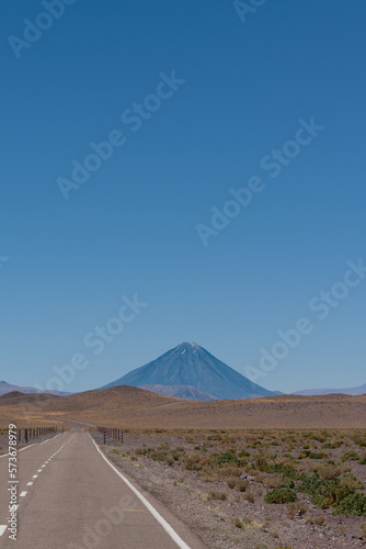 Lonely road with Licancabur Volcano in the background