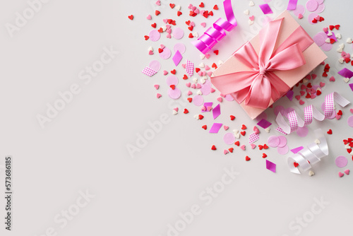 Celebration concept with pink confetti  gift and event decoration on white background