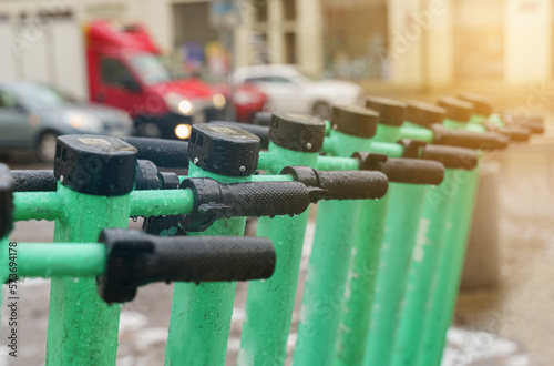 Electric scooters for public use standing in the center of a European city.