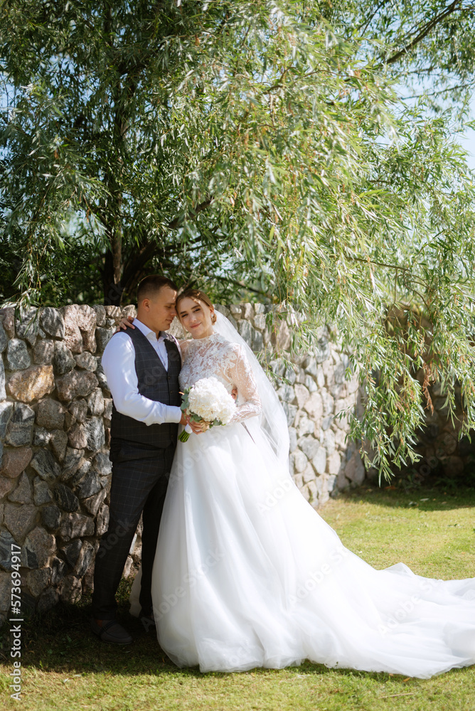young couple the groom in a plaid suit and the bride in a chic white dress