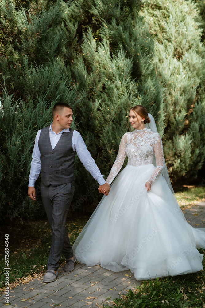 young couple the groom in a plaid suit and the bride in a chic white dress