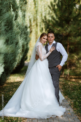 young couple the groom in a plaid suit and the bride in a chic white dress