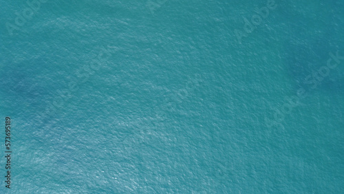 Blue water texture. Top view of the ocean surface with waves