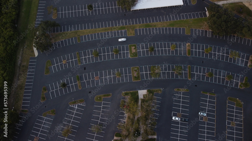 Ariel View sunset, sunset over empty parking lot,  
with random cars road