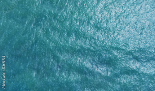 Blue water texture. Top view of the ocean surface with waves