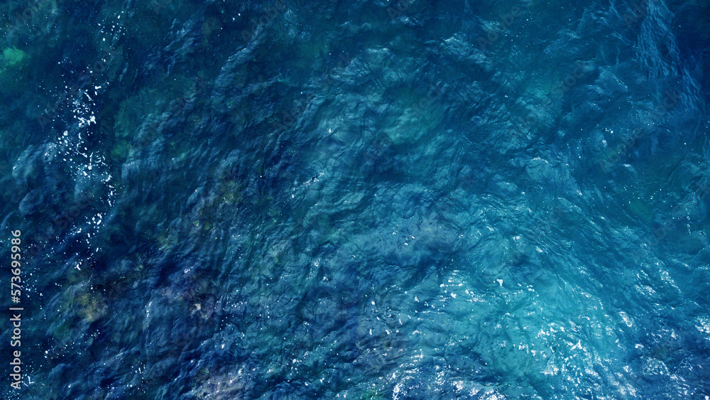 Obraz premium Blue water texture. Top view of the ocean surface with waves