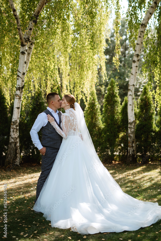 young couple the groom in a plaid suit and the bride in a chic white dress