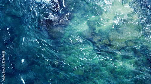 Blue water texture. Top view of the ocean surface with waves