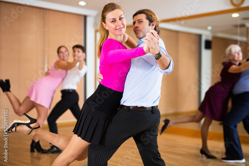 woman choreographer paired with partner dance samba in class with their students