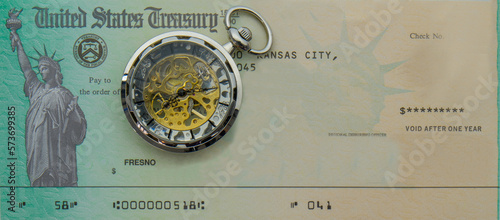 Photography Photo of blank US Treasury check mock up with a modern pocket watch on top