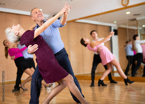 active elderly people attend dance lessons for amateurs and learn to dance waltz in their free time