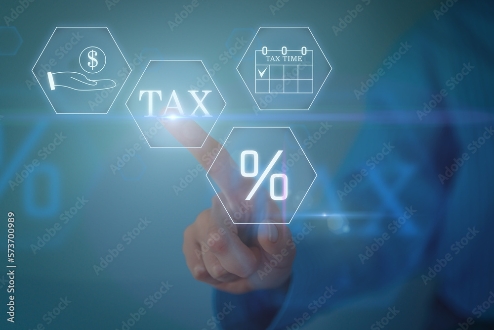 Hand clicks virtual screen to tax return online for tax payment by corporations, income tax, and property tax Hand clicks virtual screen to tax return online for tax payment by corporations, income tax, and property tax