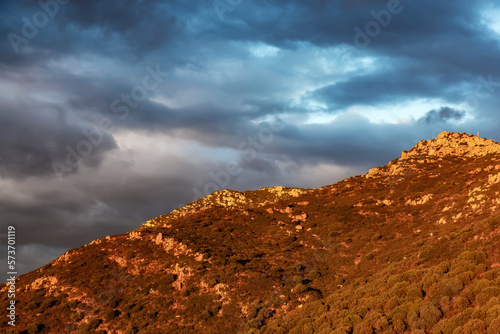 Rocky Mountains on the Sea Coast of Sardinia, Italy. Dramatic Sunset Sky. Nature Background.