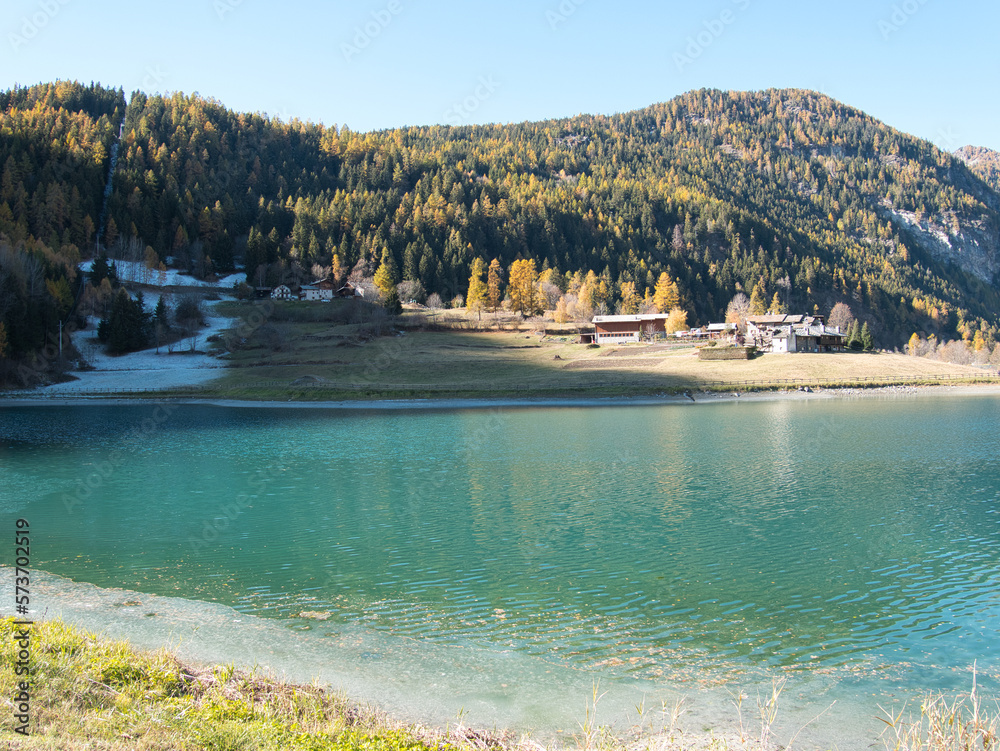 Brusson lake in autumn. Ayas valley, Italy.